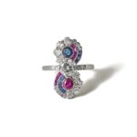 Art Deco Platinum Diamond, Sapphire and Ruby Crossover infinity Ring, c. 1920s–30s.